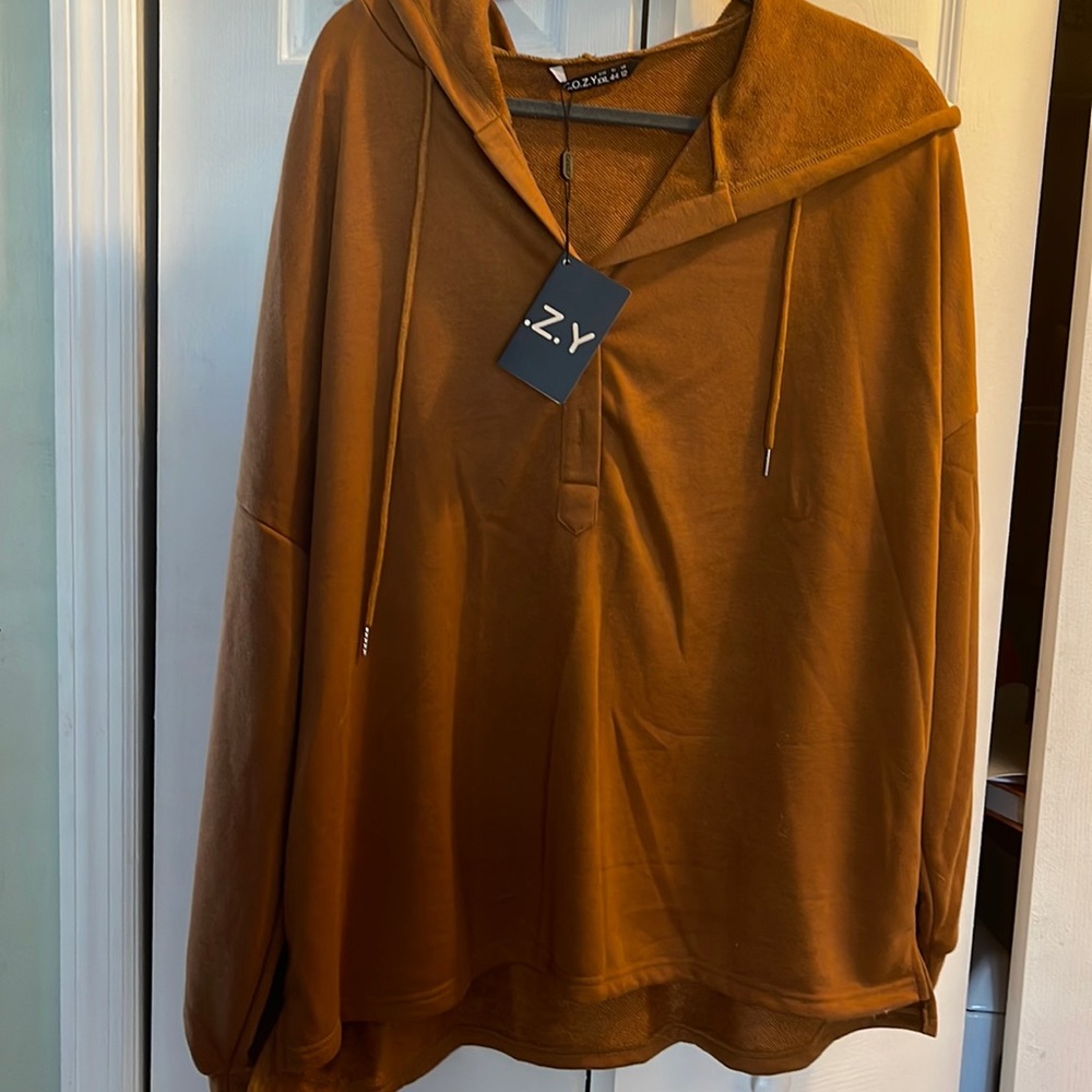 Hooded sweat top with 2 buttons in front. Dress it up or  casual